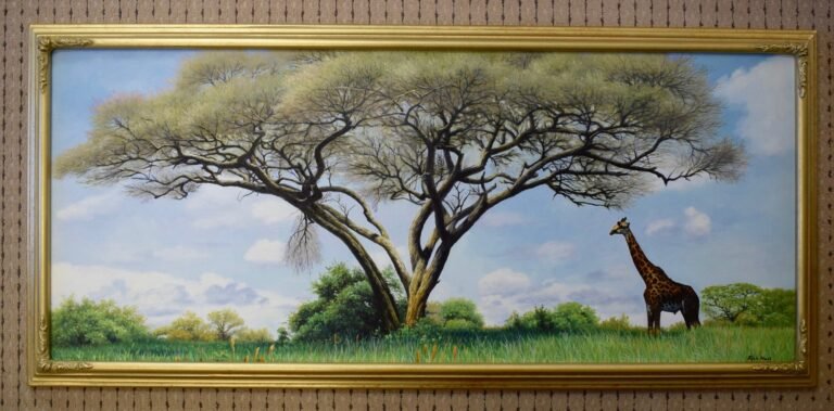 Landscape painting of a spreading tree and a giraffe, shown in a gold frame