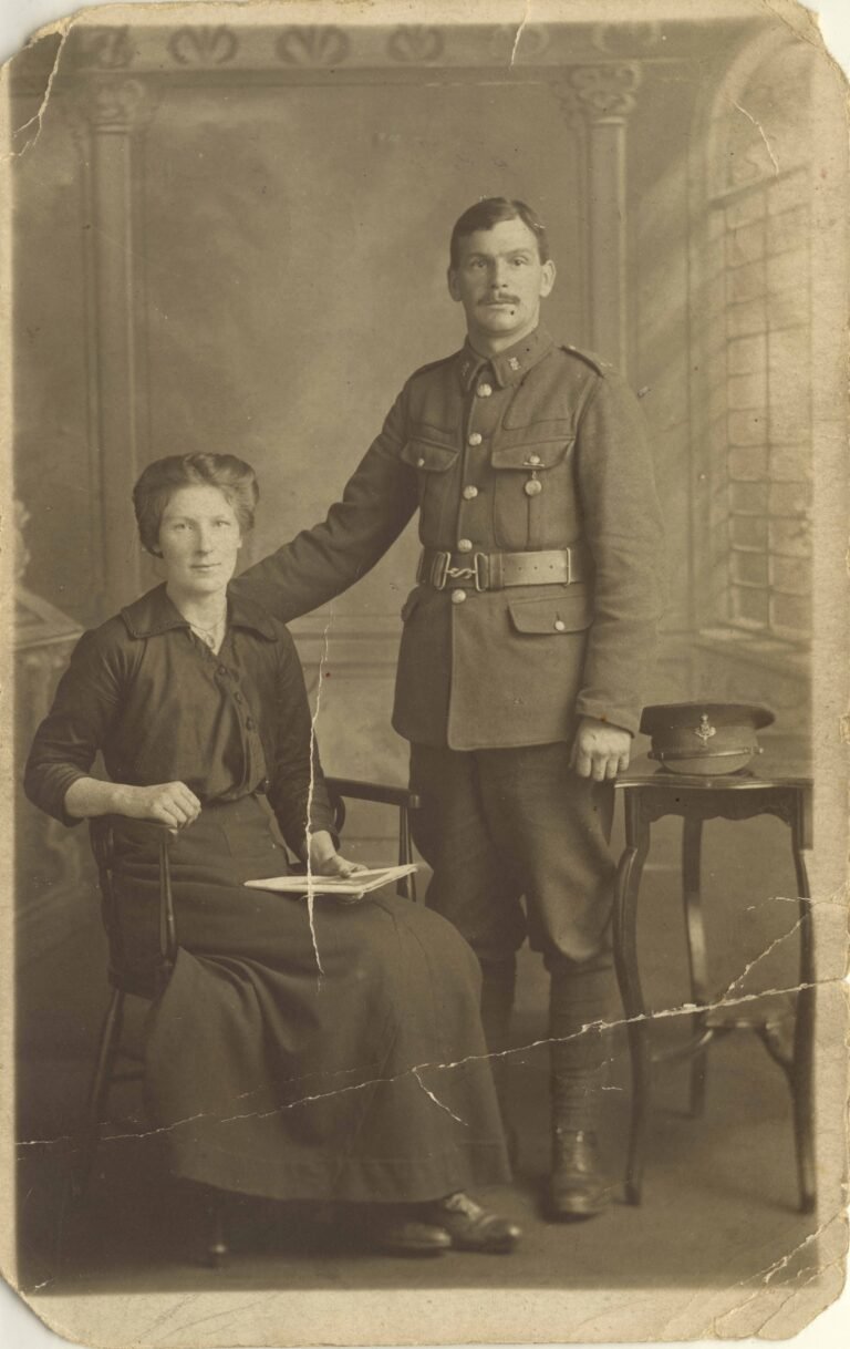 Early family photograph of a soldier standing beside a seated woman